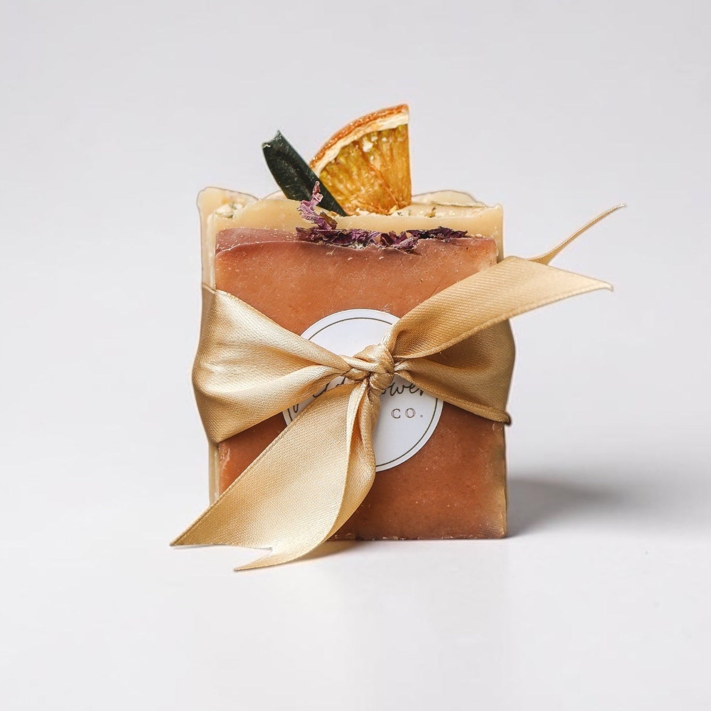 Sampler Soaps with a gold ribbon on a white background