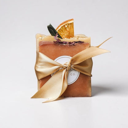 Sampler Soaps with a gold ribbon on a white background